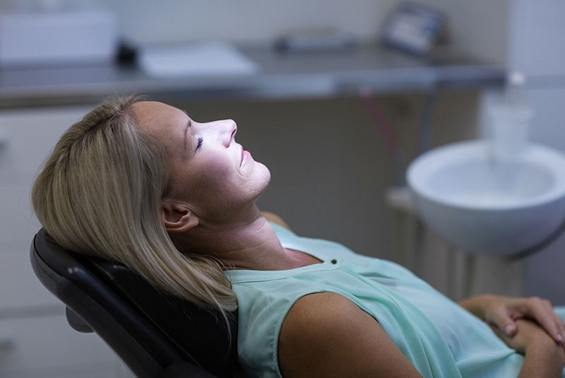 dental patient sedated in exam chair